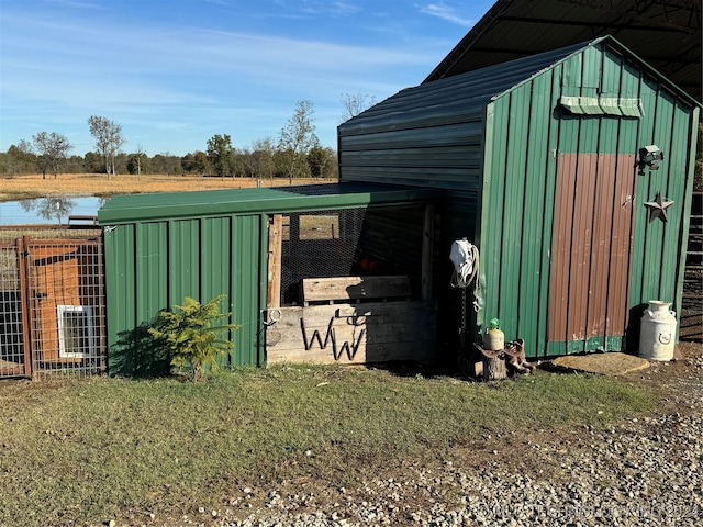 view of outbuilding with a water view