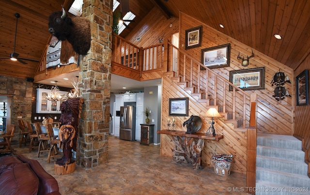 living room with high vaulted ceiling, wood walls, and wood ceiling