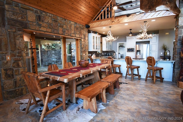 dining area with wood ceiling and high vaulted ceiling