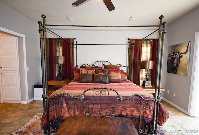 bedroom with a textured ceiling and ceiling fan