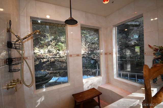 doorway to outside featuring tile walls