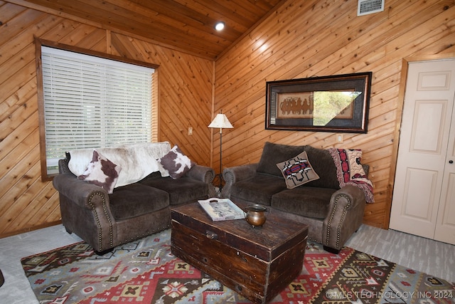 carpeted living room with wood walls, vaulted ceiling, and wooden ceiling