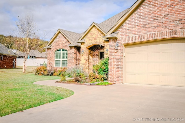 view of front of house featuring a garage and a front lawn