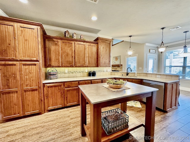 kitchen with sink, backsplash, a kitchen island, decorative light fixtures, and stainless steel dishwasher