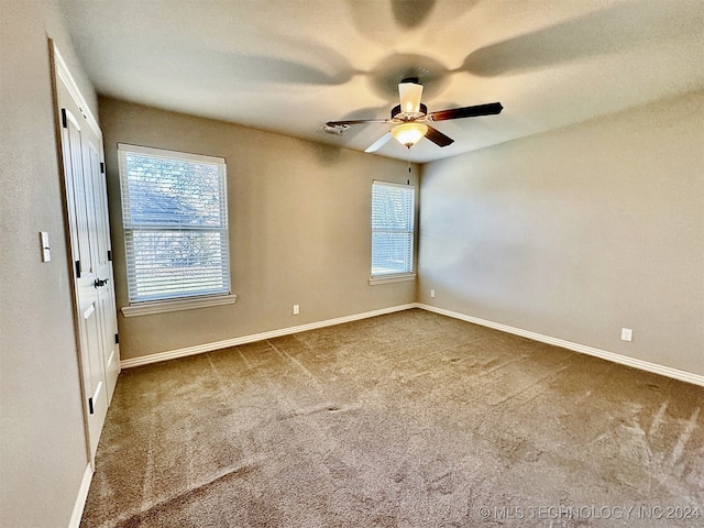 empty room featuring ceiling fan and carpet floors