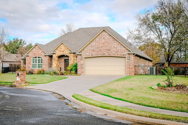 view of front of property with a garage and a front yard