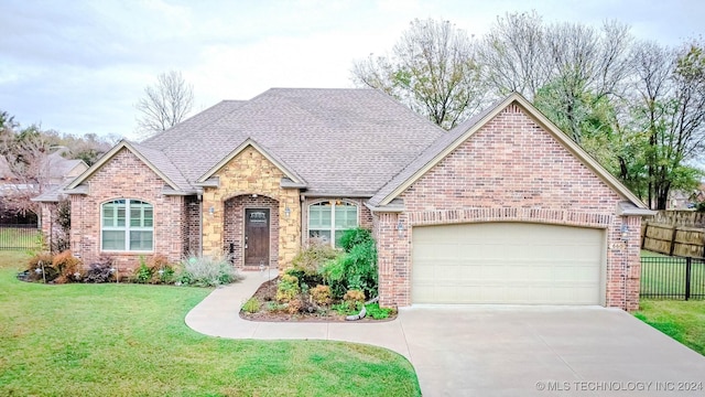 view of front facade with a garage and a front lawn