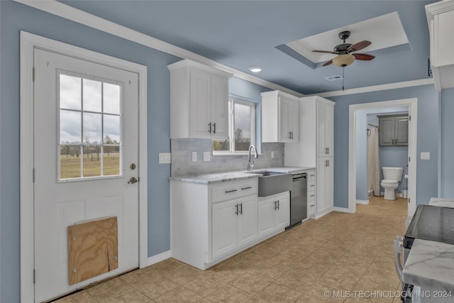 kitchen featuring appliances with stainless steel finishes, sink, decorative backsplash, white cabinets, and ceiling fan