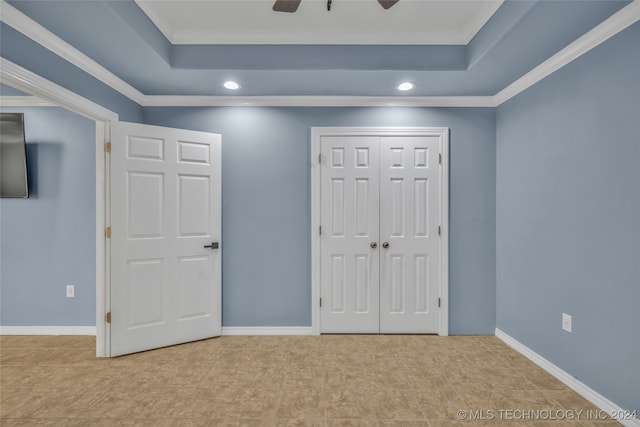 unfurnished bedroom featuring light tile patterned floors, ceiling fan, a closet, and crown molding