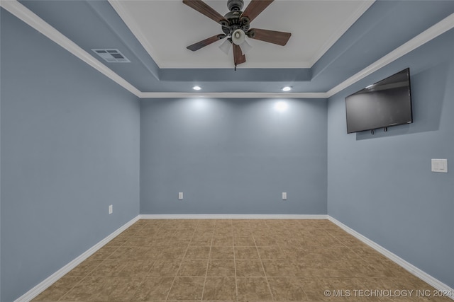 unfurnished room featuring a tray ceiling, tile patterned flooring, ceiling fan, and crown molding