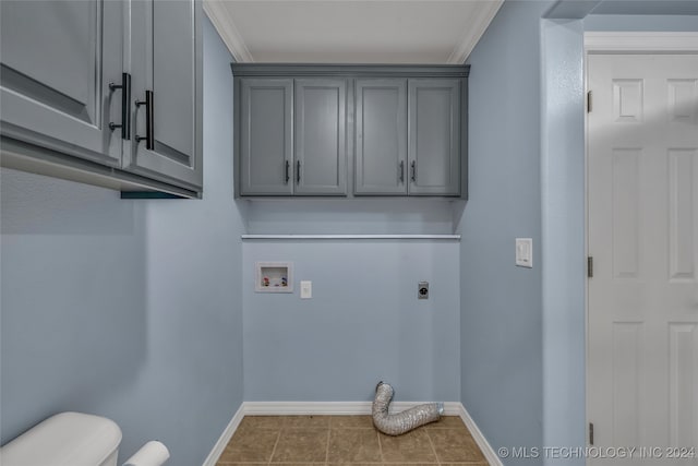 laundry area featuring tile patterned floors, ornamental molding, hookup for an electric dryer, washer hookup, and cabinets