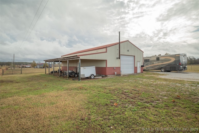 view of outbuilding featuring a lawn and a garage