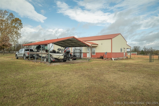 view of vehicle parking featuring a yard and a carport