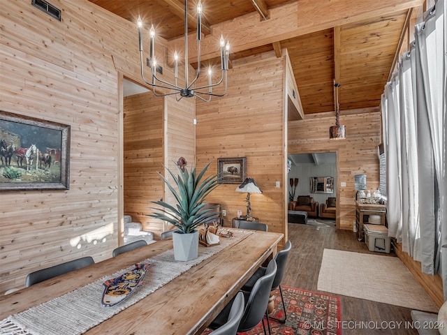 dining space with dark wood-type flooring, beamed ceiling, and a towering ceiling