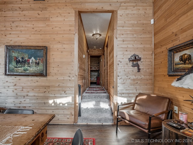 sitting room featuring wood walls and hardwood / wood-style flooring