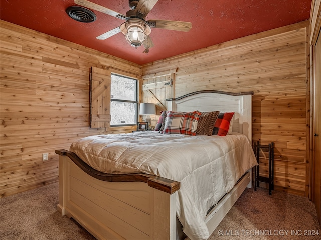 bedroom featuring wooden walls, ceiling fan, and carpet floors