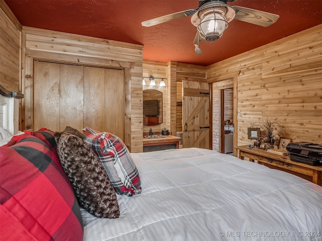 bedroom featuring ceiling fan and wooden walls