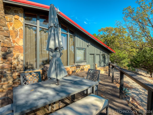 view of patio / terrace with a deck and outdoor dining space