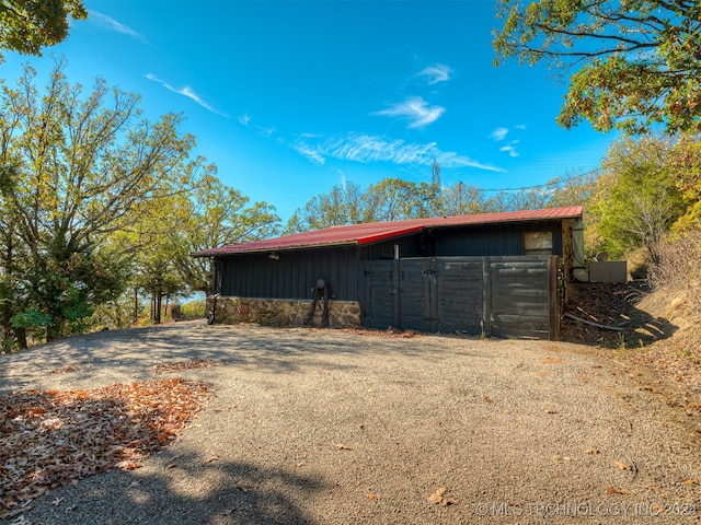 view of home's exterior with an outbuilding