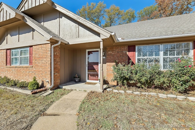 doorway to property with a lawn