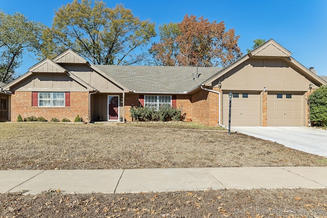 view of front of property featuring a front yard and a garage