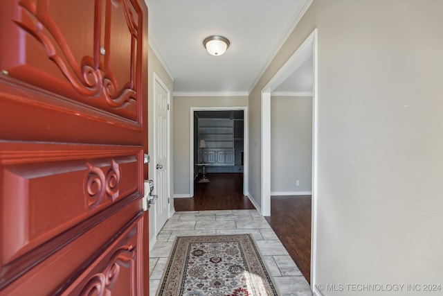 entrance foyer with light hardwood / wood-style floors and crown molding