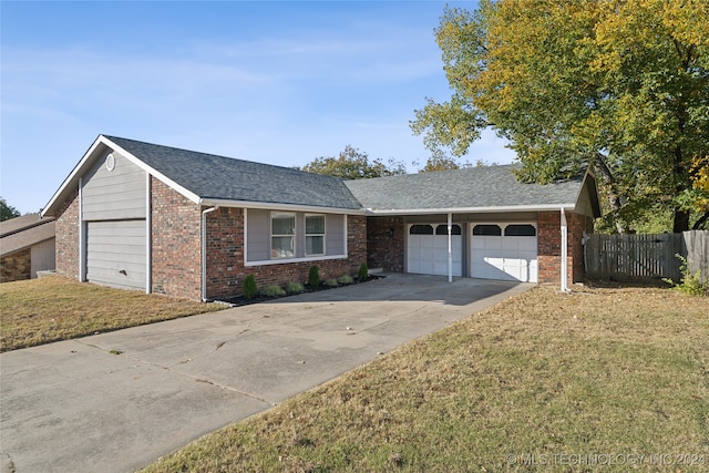 ranch-style house with a front lawn and a garage