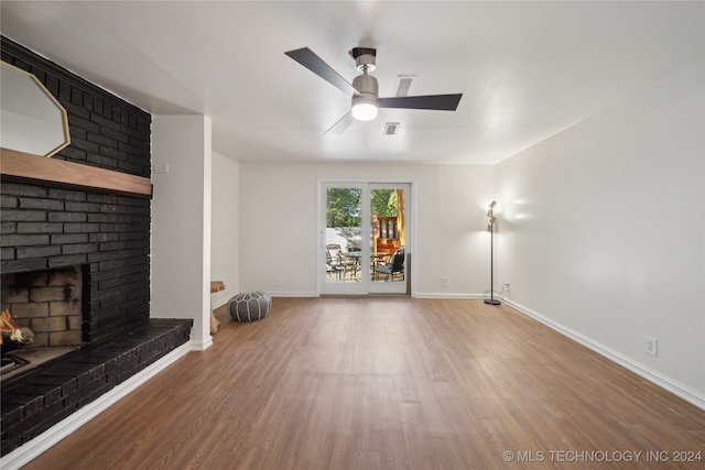 unfurnished living room featuring a fireplace, hardwood / wood-style flooring, and ceiling fan