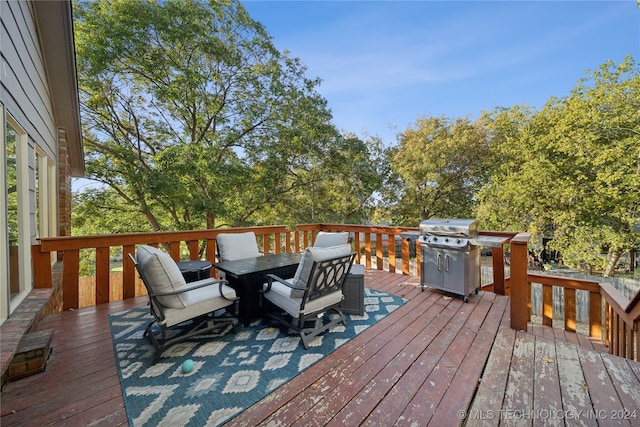 wooden deck featuring a grill