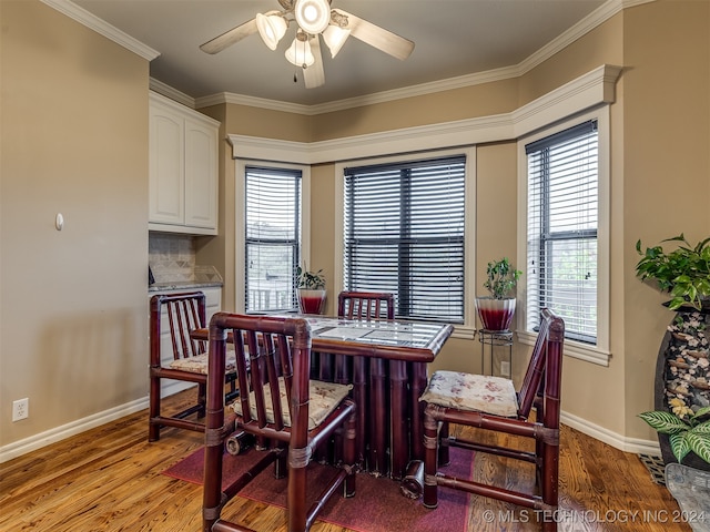 dining area featuring light wood-type flooring, ceiling fan, and crown molding