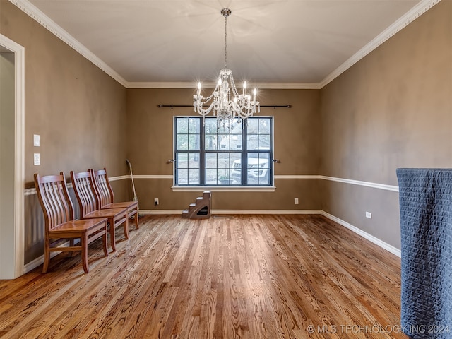 interior space with a chandelier, hardwood / wood-style floors, and crown molding