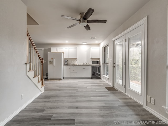 interior space featuring light wood-type flooring and ceiling fan