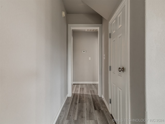 hall with hardwood / wood-style flooring