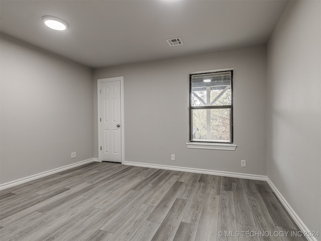 unfurnished room with light wood-type flooring