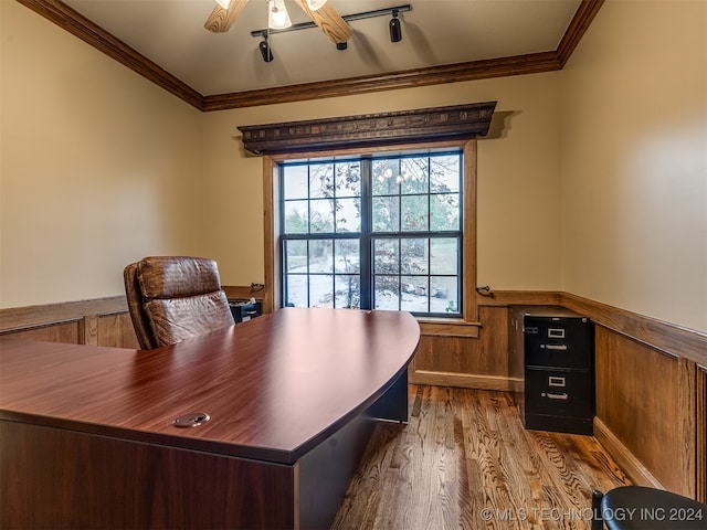 office space featuring ceiling fan, wooden walls, hardwood / wood-style flooring, and ornamental molding