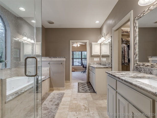 bathroom featuring vanity, ceiling fan, and plus walk in shower