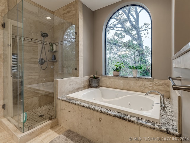 bathroom with tile patterned flooring and separate shower and tub