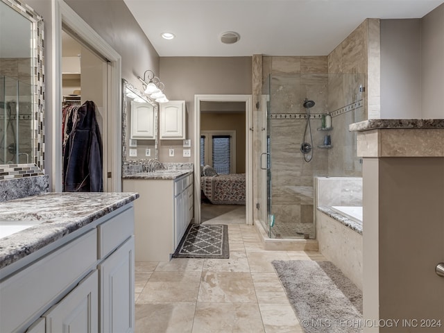 bathroom with independent shower and bath and vanity