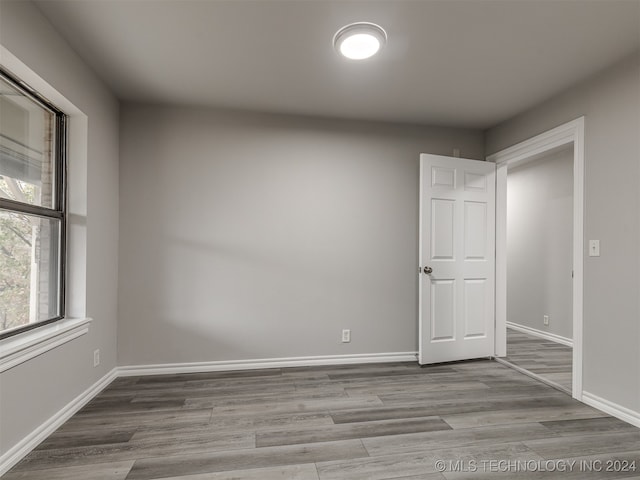 empty room with hardwood / wood-style flooring