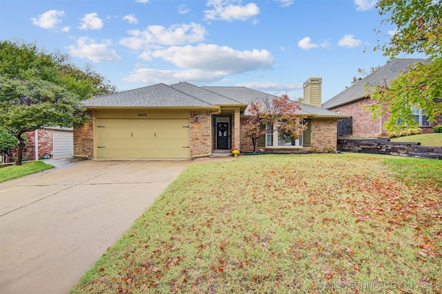 ranch-style house featuring a garage and a front lawn