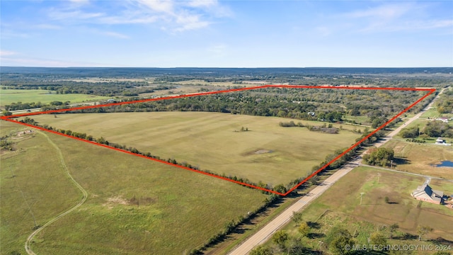 birds eye view of property with a rural view