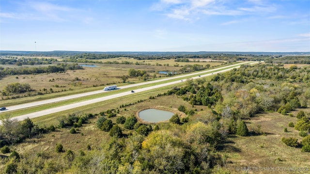 birds eye view of property with a rural view