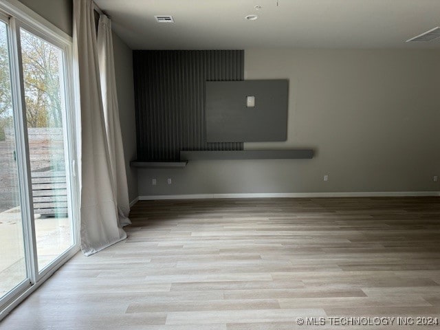 empty room with light hardwood / wood-style flooring