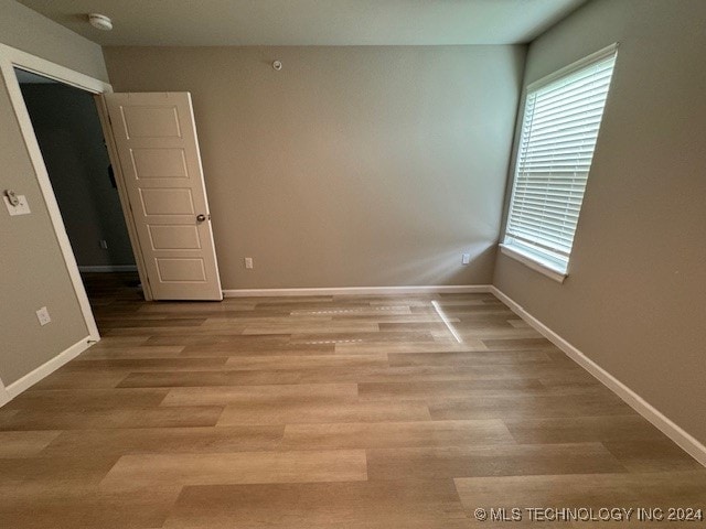 spare room with light hardwood / wood-style flooring