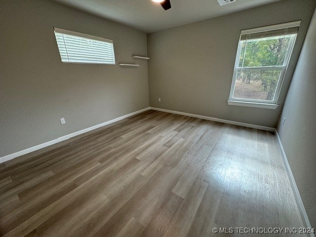 empty room featuring light hardwood / wood-style flooring and ceiling fan