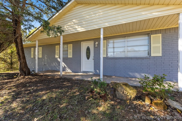 doorway to property featuring a porch