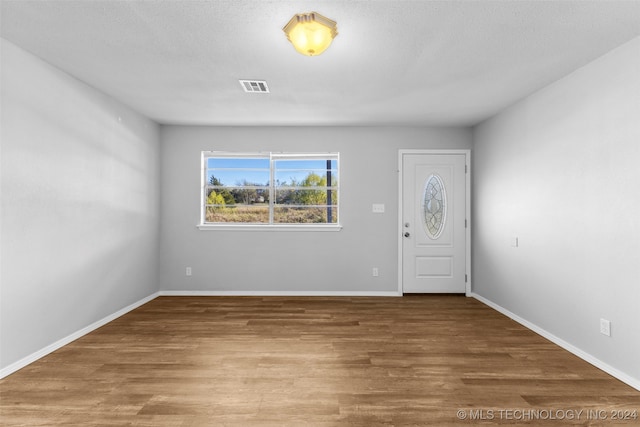 entrance foyer featuring wood-type flooring and a textured ceiling