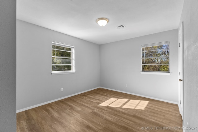 unfurnished room featuring hardwood / wood-style flooring