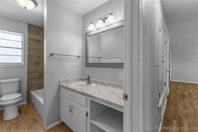 bathroom featuring hardwood / wood-style flooring, vanity, and toilet