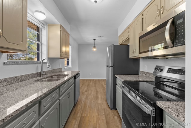 kitchen with light hardwood / wood-style flooring, sink, gray cabinetry, appliances with stainless steel finishes, and decorative light fixtures